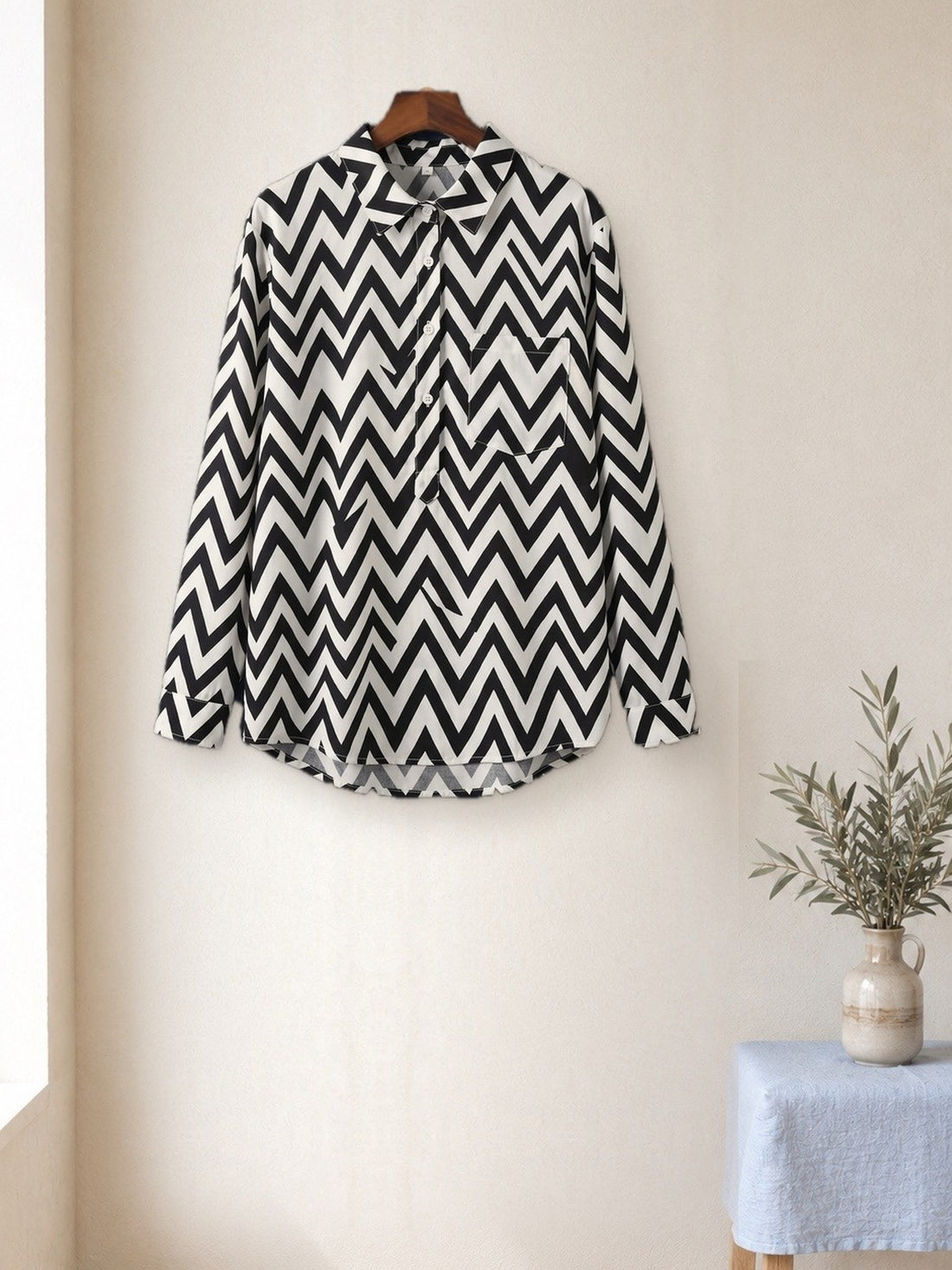 Black & White Zigzag Shirt hanging in a bright studio