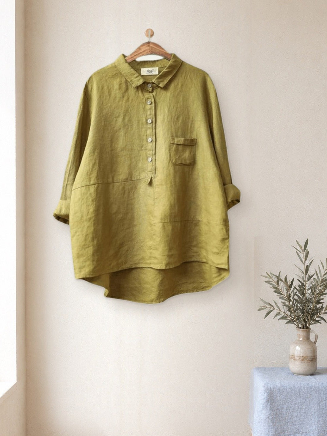 Linen-Look Pocket Shirt hanging in a bright studio