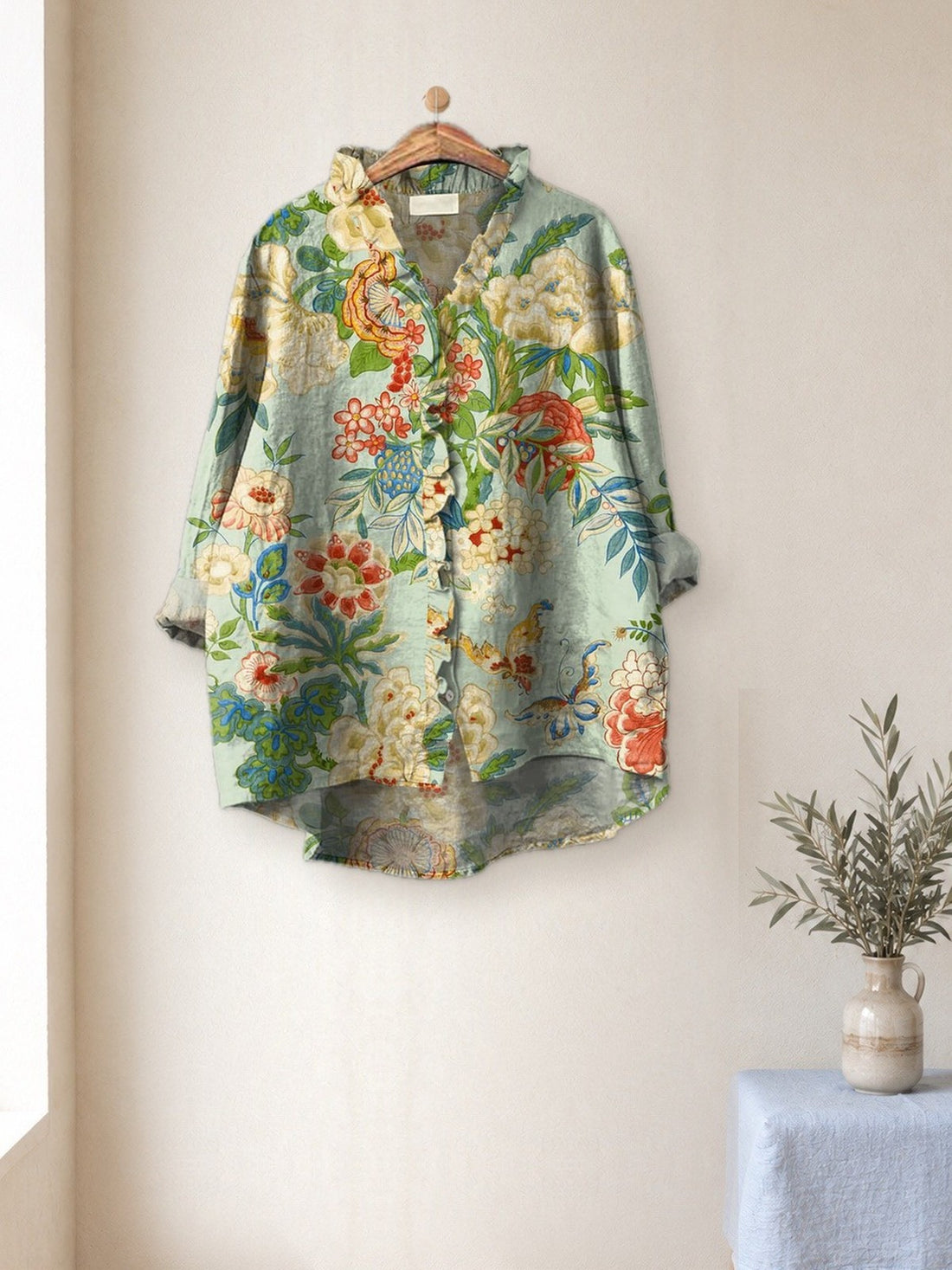 Mint Botanical Garden Shirt hanging in a bright studio