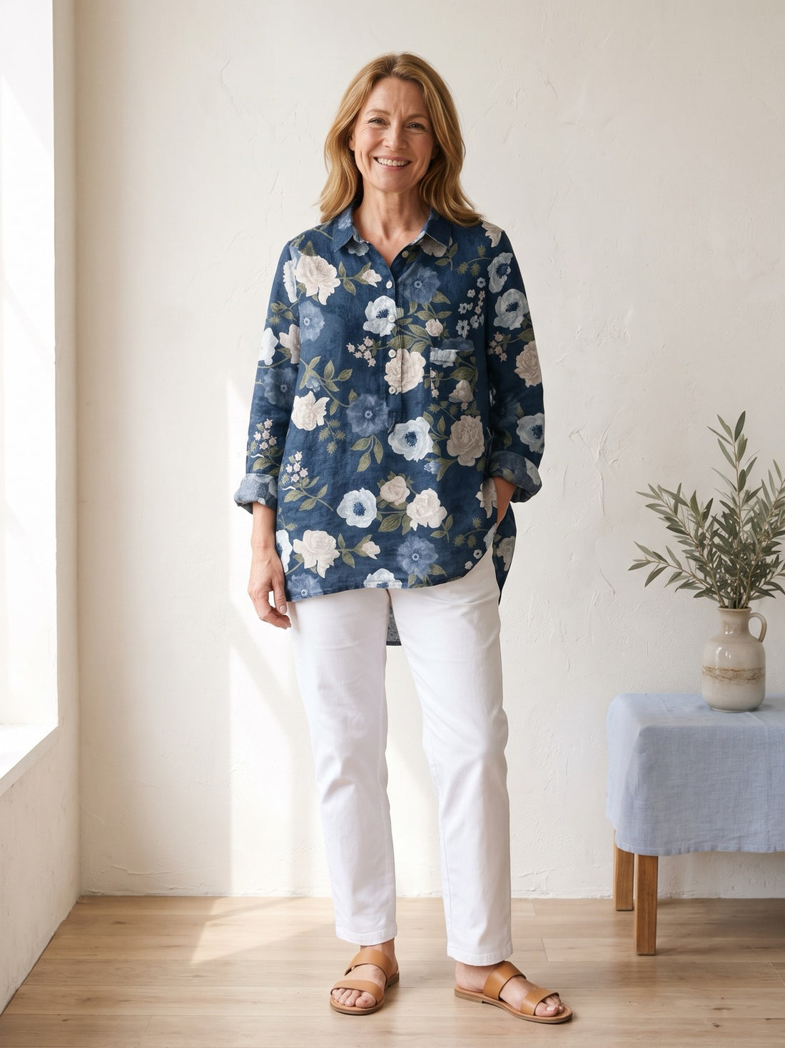 Woman in her fifties wearing the Navy White Rose Shirt with white trousers