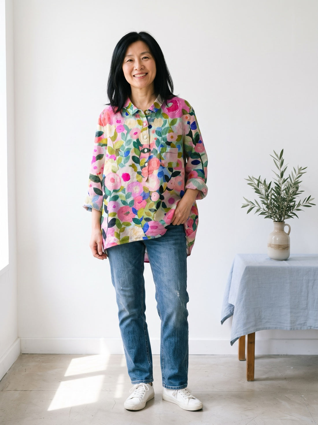 Woman around fifty wearing the Pink Blossom Print Shirt with jeans