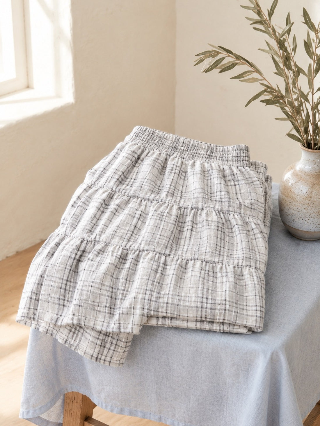 Plaid Maxi Tiered Skirt folded on a stool, showing the check and tiers
