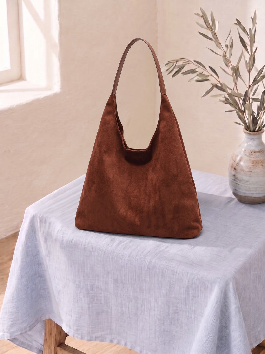Suede-Look Hobo Bag on a linen-covered stool