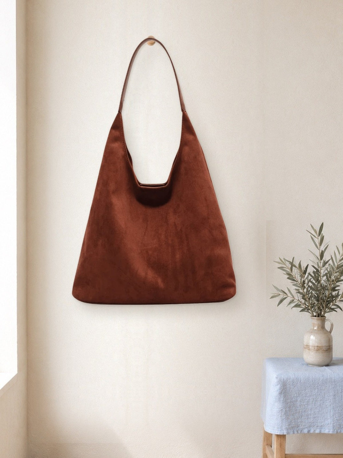 Suede-Look Hobo Bag hanging in a bright studio