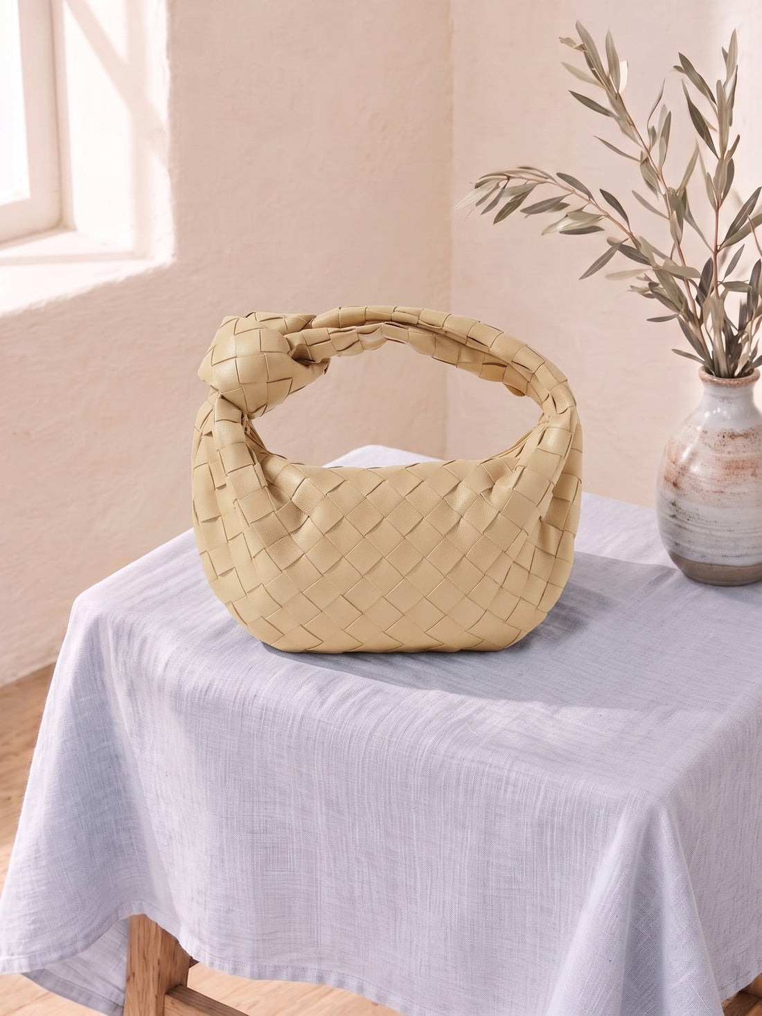 Woven Knot Handbag on a linen-covered stool
