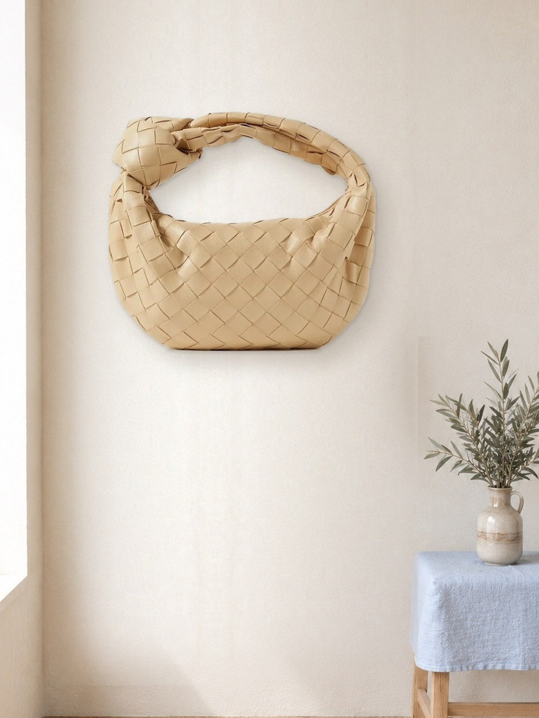 Woven Knot Handbag hanging in a bright studio