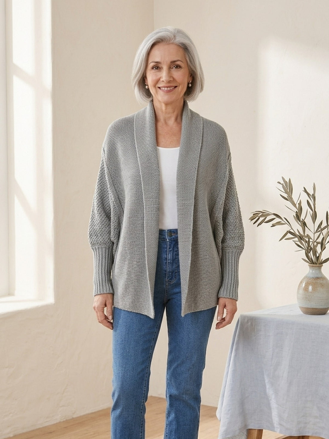 Woman in her sixties wearing the grey Chunky Batwing Cardigan with jeans