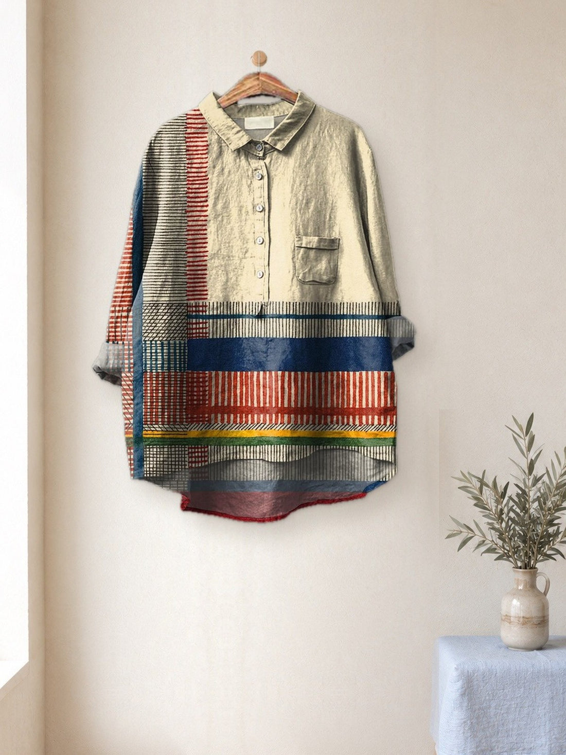 Cream Striped Patchwork Shirt hanging in a bright studio