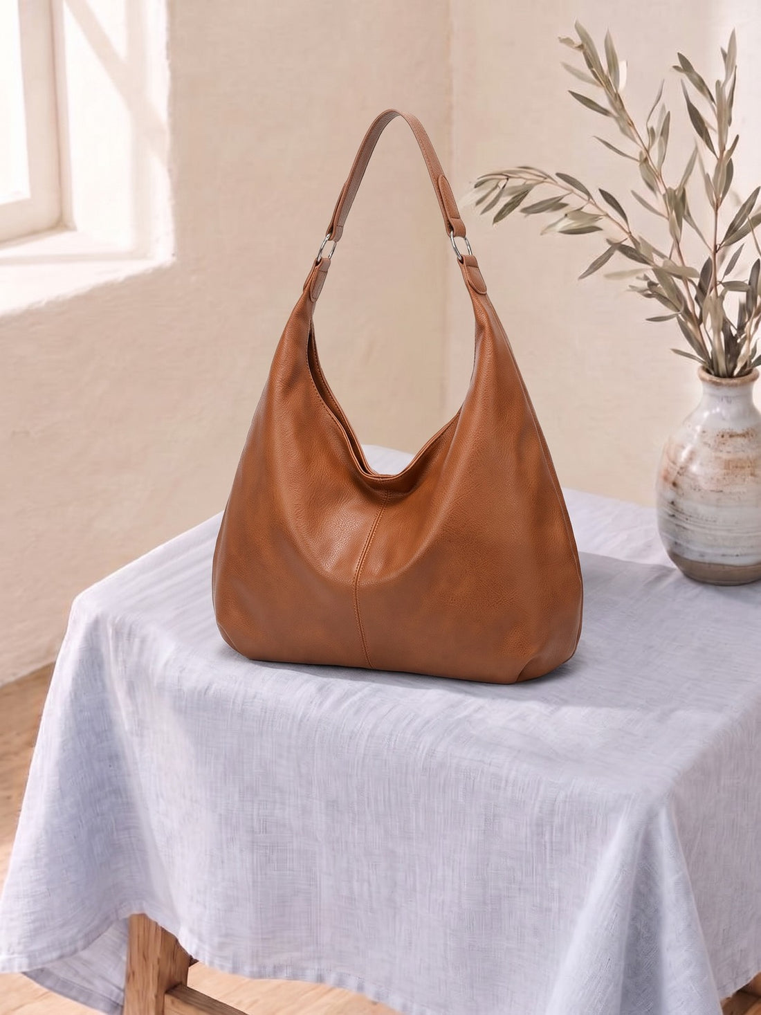 Leather-Look Hobo Shoulder Bag on a linen-covered stool