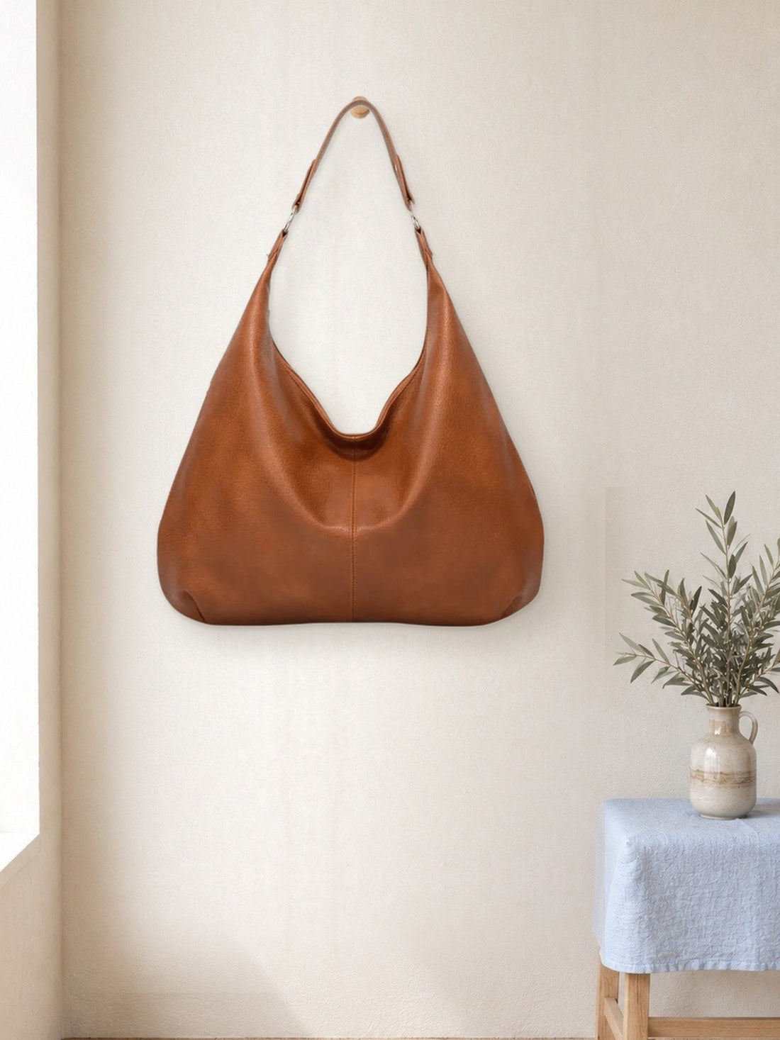 Leather-Look Hobo Shoulder Bag hanging in a bright studio