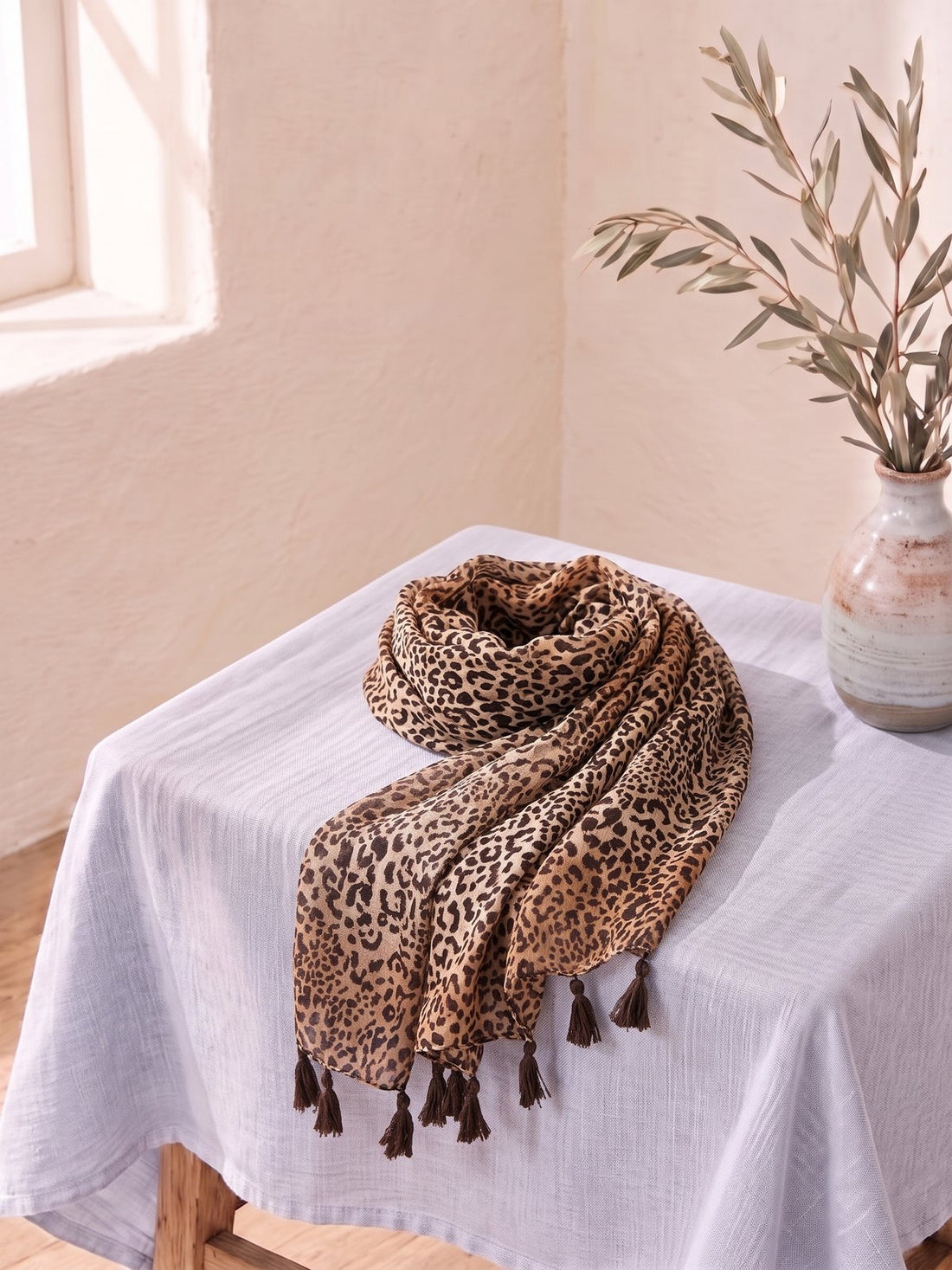Leopard Print Scarf draped on a linen-covered table