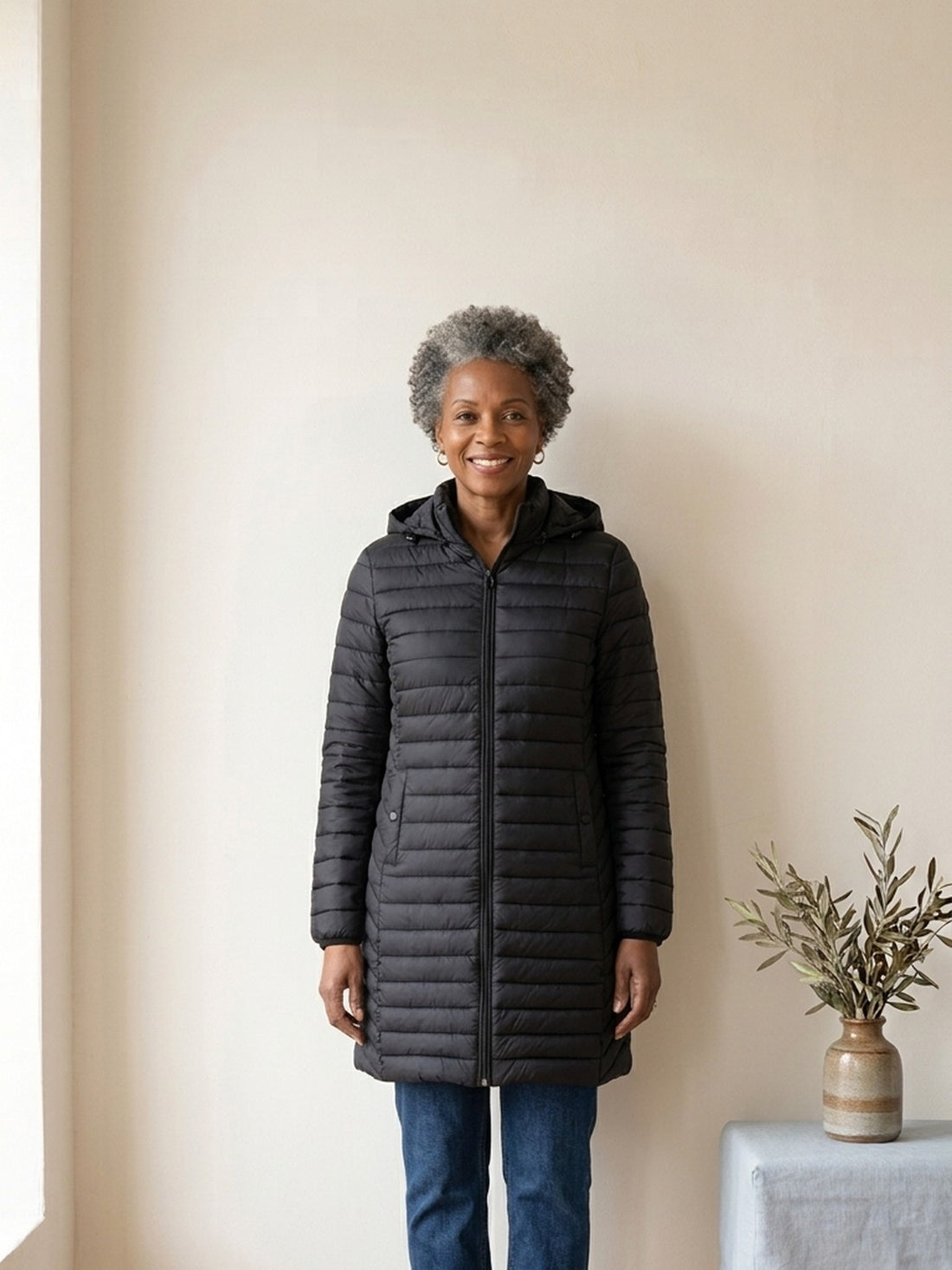 Woman in her fifties wearing the black Long Padded Hooded Parka
