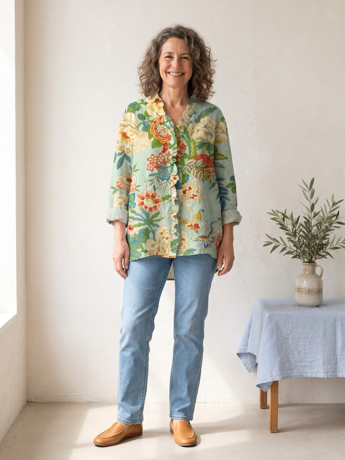 Woman in her fifties wearing the Mint Botanical Garden Shirt with light jeans