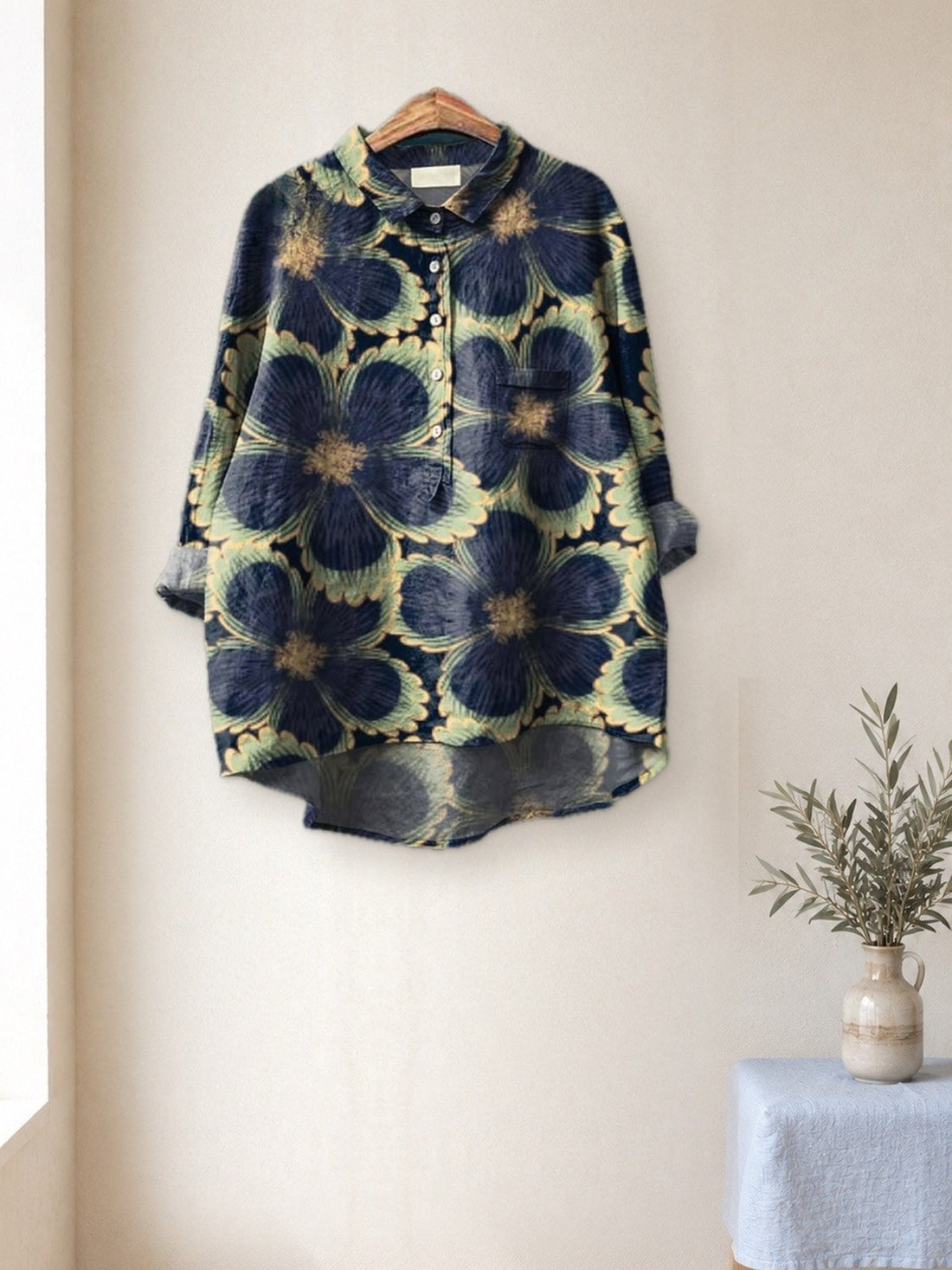Navy Bold Flower Shirt hanging in a bright studio