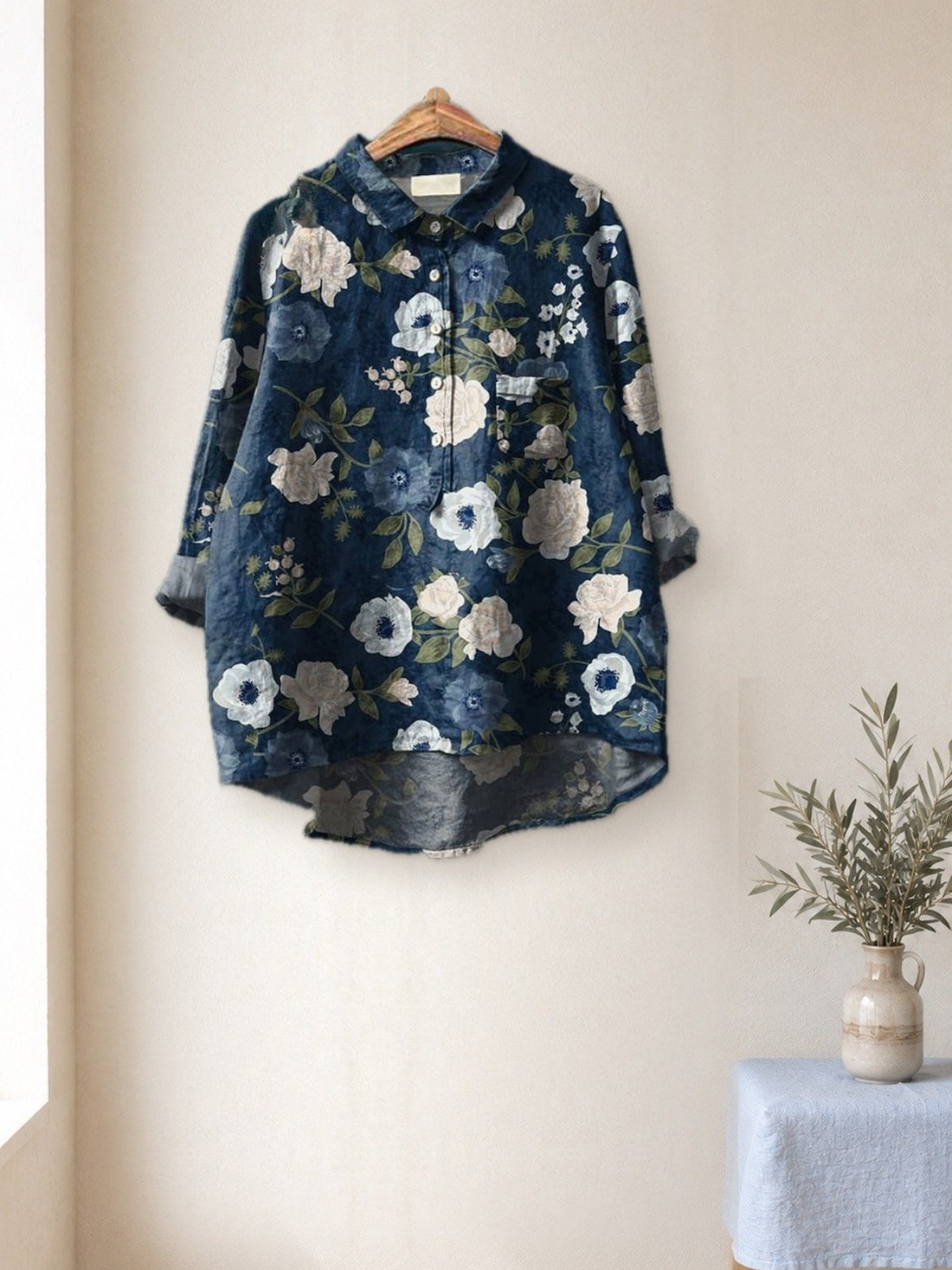 Navy White Rose Shirt hanging in a bright studio