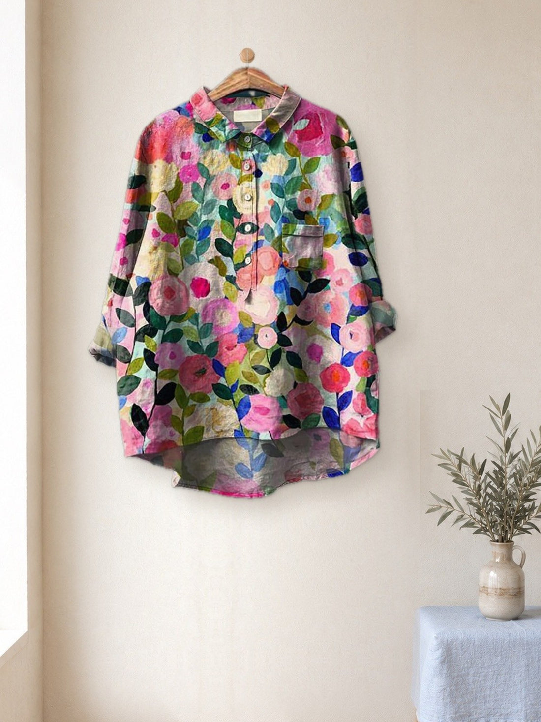 Pink Blossom Print Shirt hanging in a bright studio