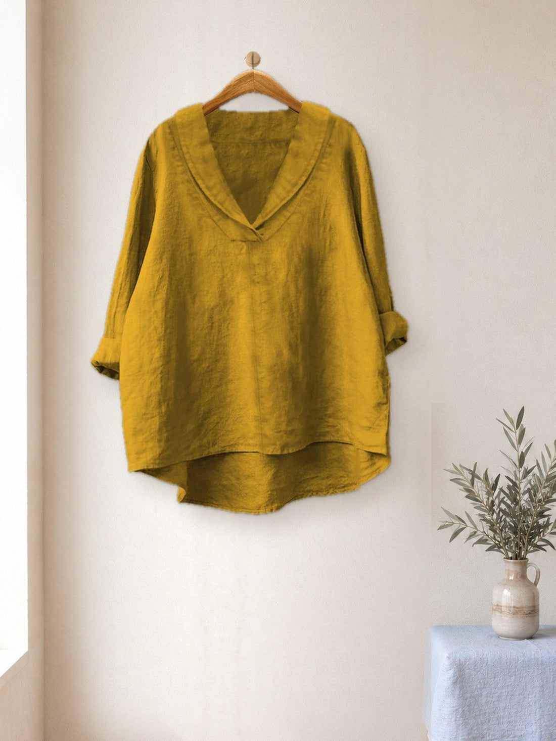 Relaxed V-Neck Linen-Look Top hanging in a bright studio