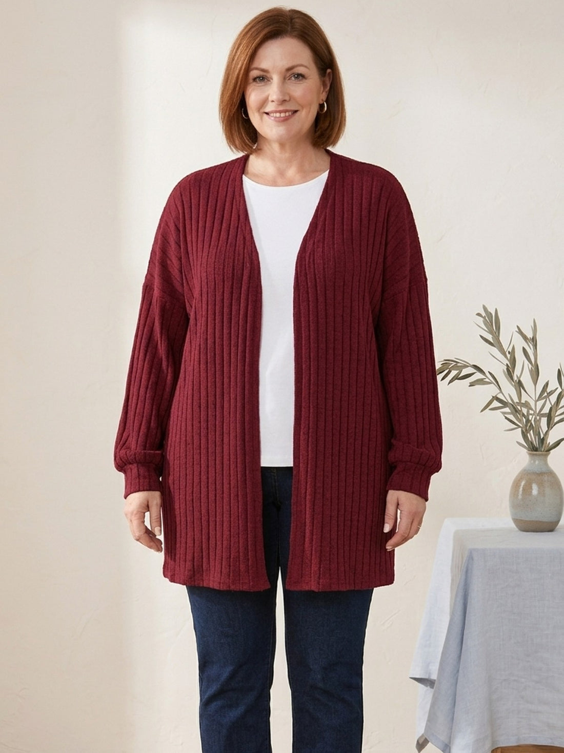 Curvy woman in her fifties wearing the burgundy Ribbed Open Cardigan