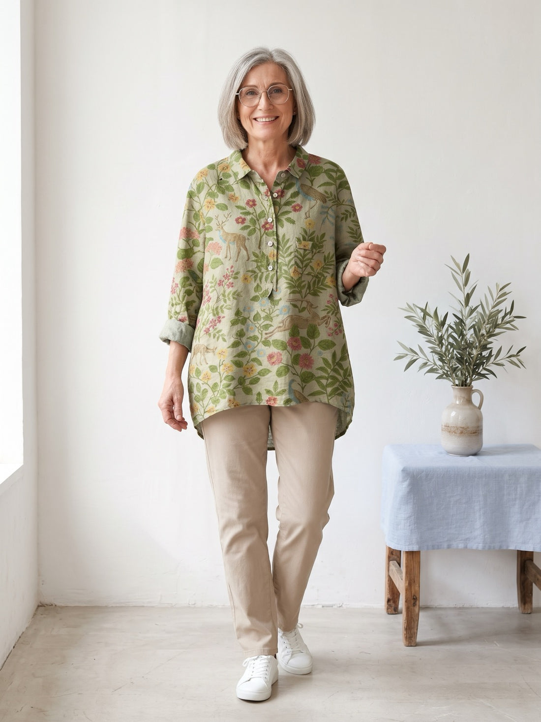 Woman around sixty wearing the Sage Botanical Print Shirt with beige trousers