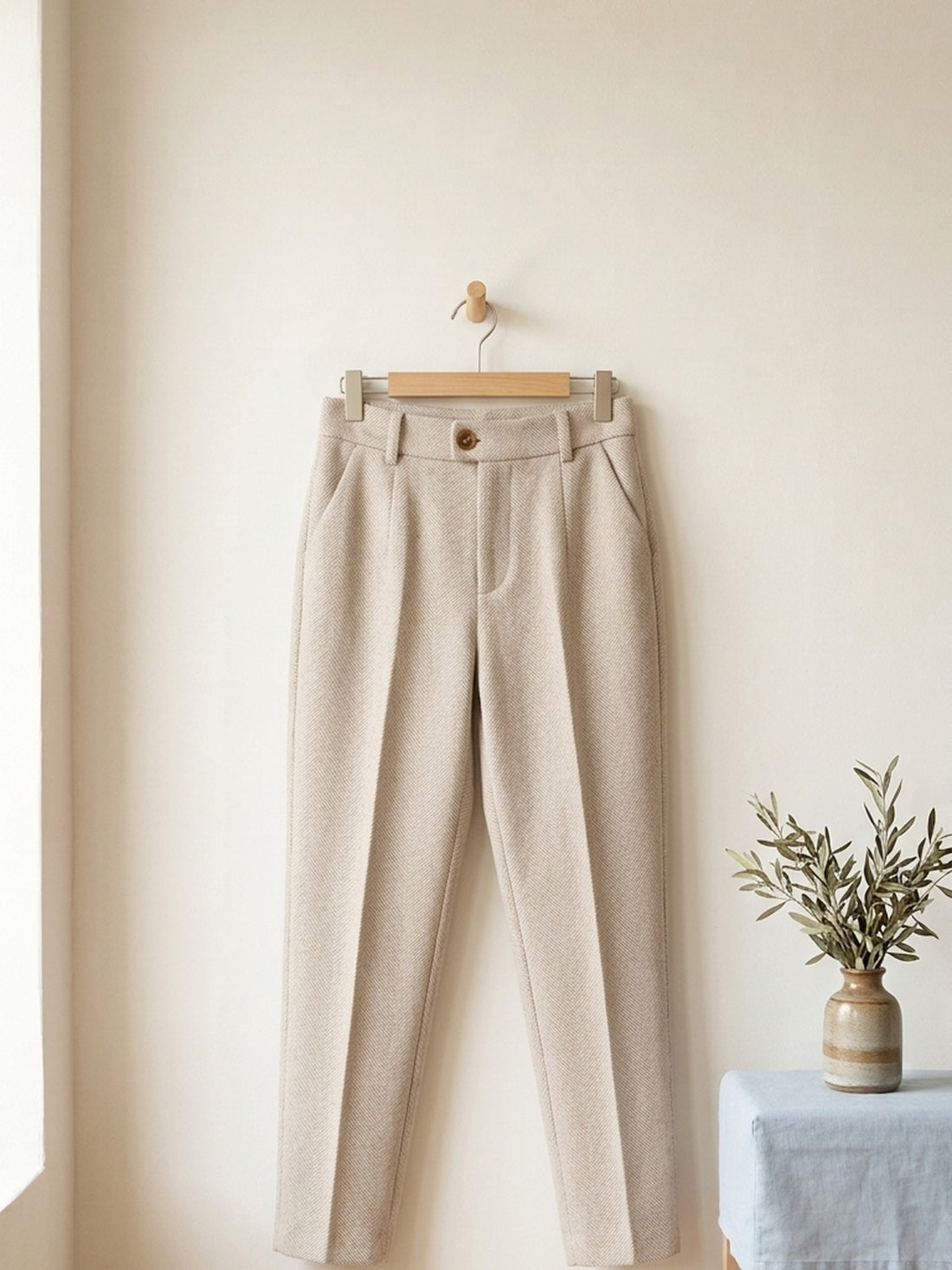 Wool-Blend Tapered Trousers on a wooden hanger